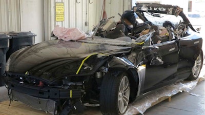 This image provided by the National Transportation Safety Board shows the damage to the left front of the Tesla involved in a May 7, 2016, crash in Williston, Fla. Investigators are meeting Sept. 12, 2017, to determine the likely cause of the crash that killed Joshua Brown, 40, of Canton, Ohio, who was using the semiautonomous driving systems of his Tesla Model S sedan. The sedan struck the underside of a semitrailer that was turning onto a divided highway in Williston. The sedan's roof was sheared off before the vehicle emerged on the other side of the trailer.