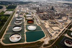 In this Wednesday, Aug. 30, 2017 file photo, large storage tanks situated in retention ponds are surrounded by rainwater left behind by Tropical Storm Harvey at ExxonMobil's refinery in Baytown, Texas. Companies have reported that roughly two dozen storage tanks holding crude oil, gasoline and other fuels collapsed or otherwise failed during Harvey, spilling a combined 140,000 gallons of fuel, according to an Associated Press analysis of state and federal accident databases. Federal rules require companies to be prepared for spills, but don't require them to take any specific measures to secure the massive fuel storage tanks at refineries and oil production sites that are prone to float and break during floods.