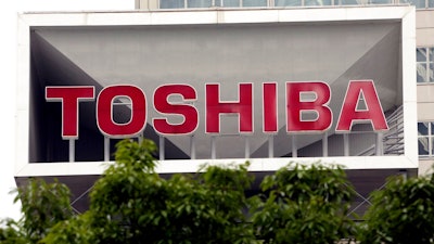 This May 26, 2017 file photo shows the company logo of Toshiba Corp. displayed in front of its headquarters in Tokyo. Toshiba's long meandering sale of its computer memory business is taking another turn, as the Japanese nuclear and electronics company's announcement of a deal with a consortium was immediately met with opposition from U.S. joint venture partner Western Digital.