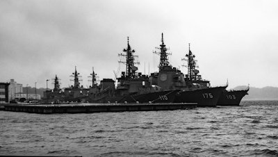 An Arleigh Burke-class destroyer anchored at the United States Fleet Activities Yokosuka Navy base.