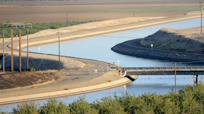 In this Oct. 2, 2009 file photo, in California's Westland Water District of the Central Valley, canals carry water to southern California. A new federal audit says the federal government improperly spent tens of millions of dollars on the California water project. An audit by the inspector general's office of the U.S. Interior Department says federal officials contributed the taxpayer money to Gov. Jerry Brown's plans to build two giant water tunnels.
