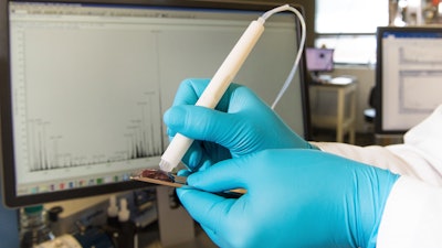 This photo provided by the University of Texas at Austin shows the MasSpec Pen, a handheld probe that can non-destructively analyze human tissue samples to identify cancer. Scientists are developing a highly experimental pen-like probe to help surgeons better tell when it's safe to stop cutting or if stray tumor cells still lurk.