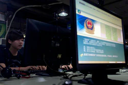 In this Aug. 19, 2013 file photo, computer users sit near a monitor display with a message from the Chinese police on the proper use of the Internet at an Internet cafe in Beijing, China. China's campaign to stamp out use technology that allows web surfers to evade its internet filters is disrupting work and study for entrepreneurs, scientists and students. The crackdown comes as the ruling Communist Party tightens political control ahead of a congress at which President Xi Jinping is due to be appointed to a second 5-year term as leader.