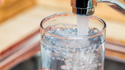 Water plant operator came under scrutiny when schools closed and pregnant women were warned not to drink tap water.