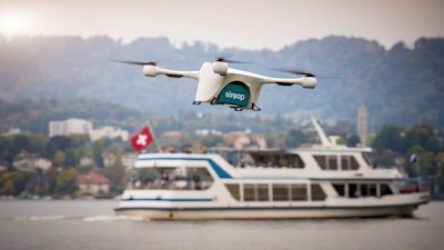 In this image made available from Matternet Thursday Sept. 28, 2017, a Matternet drone is pictured transporting on-demand e-commerce goods in Zurich, Switzerland. Drones will soon start to deliver small items in Zurich as part of a pilot project, the first of its kind over a populated area, transporting goods about 8 to 16 kilometers (5 to 10 miles) to awaiting delivery vans and the van drivers will then deliver them to customers.