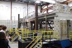 Researchers and invited dignitaries watch gathered at the University of Nevada, Reno's new Earthquake Engineering Laboratory in Reno, Nev., on Wednesday, Sept. 20, 2017, before a series of tests on new bridge designs intended to better withstand violent temblors. Scientists say the 100-ton, 70-foot-long concrete bridge subjected to violent motions on a giant ''shake table'' held up better than expected using new innovations to connect prefabricated pieces with ultra-high performance concrete and could prove pivotal in earthquake-prone places like Mexico and the western U.S.