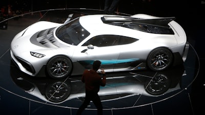 Formula One driver Lewis Hamilton films the Mercedes-AMG Project One hyper after the world premiere during an event of German carmaker Mercedes-Benz on the eve of the opening of the International Frankfurt Motor Show IAA in Frankfurt, Germany, Monday, Sept. 11, 2017, which runs through Sept. 24, 2017.