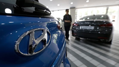 In this July 26, 2017, file photo, the logo of Hyundai Motor Co. is seen on a car displayed at its showroom in Seoul, South Korea. Hyundai Motor Co. said its China plant halted operation due to a supply disruption on Tuesday, Sept. 5, 2017 its second shutdown in China in less than a month as diplomatic tensions between China and South Korea over a U.S. missile-defense system took toll on its business.