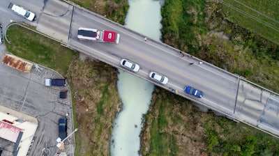 This drone photo shows an accidental milk spill at a food processing business that ended up turning a central Indiana creek white.