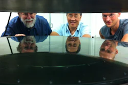 UC Santa Cruz researchers worked with Structured Materials Industries to design and build an atomic layer deposition (ALD) system large enough to accommodate telescope mirrors. Andrew Phillips, Nobuhiko Kobayashi, and David Fryauf (l to r) examine the deposition chamber.