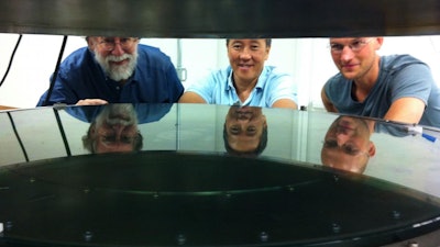 UC Santa Cruz researchers worked with Structured Materials Industries to design and build an atomic layer deposition (ALD) system large enough to accommodate telescope mirrors. Andrew Phillips, Nobuhiko Kobayashi, and David Fryauf (l to r) examine the deposition chamber.