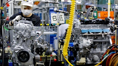 In this Aug. 2, 2017, photo, a Nissan Motor Co. factory worker checks an engine on an assembly line at its plant in Yokohama, near Tokyo. Aiming to get an edge on its rivals in an intensely competitive industry, Japanese automaker Nissan says it’s attempting to foster a corporate culture that will produce manufacturing innovations in leaps and bounds instead of steady incremental improvement. Its discussion of that effort is partly a swipe at bigger competitor Toyota Motor Corp. which for decades has favored the concept of “kaizen” or fine tuning and bit-by-bit progress in auto manufacturing.