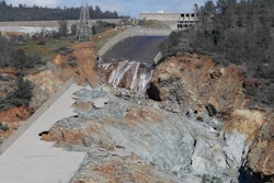 In this Feb. 28, 2017, file photo, a small flow of water goes down Oroville Dam's crippled spillway in Oroville, Calif. A towering spillway at the nation's tallest dam was crumbling and tens of thousands of people were fleeing for their lives, but as darkness fell state managers suddenly discovered the unfolding crisis in Northern California was about to get even worse: They couldn't see. For years federal regulators had urged keepers at the state-run Oroville Dam to install more cameras and other monitors to warn and guide them in just such an emergency.