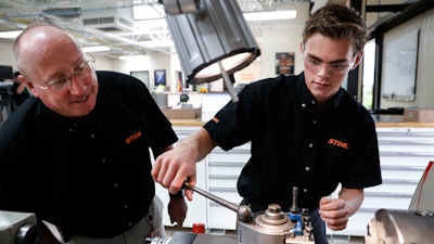 In this May 25, 2017, file photo, apprentice Ryan Buzzy, right, works with Skip Johnson, a trainer for the Stihl Inc. apprenticeship program, on a metalworking lathe in their training area at the Stihl Inc. manufacturing facility in Virginia Beach, Va. On Friday, Sept. 1, 2017, the Institute for Supply Management, a trade group of purchasing managers, issues its index of manufacturing activity for August.