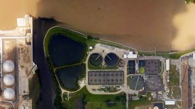 This handout aerial photo from the National Oceanic and Atmospheric Administration shows floodwaters surrounding the U.S. Oil Recovery Superfund site outside Houston flowing into the San Jacinto River. The Environmental Protection Agency says it has found no evidence that toxins washed off the site, but is still assessing damage.