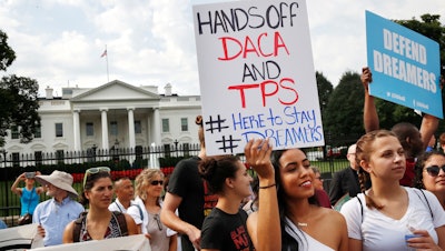 Yurexi Quinones, 24, of Manassas, Va., a college student who is studying social work and a recipient of Deferred Action for Childhood Arrivals, known as DACA, rallies next to Ana Rice, 18, of Manassas, Va., far right, in support of DACA, outside of the White House in Washington, Tuesday, Sept. 5, 2017. President Donald Trump plans to end a program that has protected hundreds of thousands of young immigrants brought into the country illegally as children and call for Congress to find a legislative solution.
