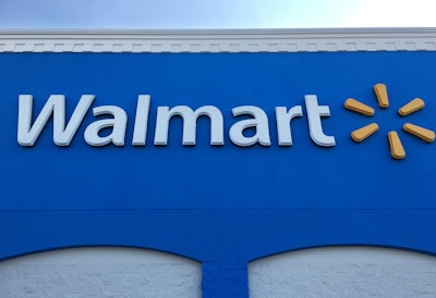 This Thursday, Jan. 5, 2017, photo shows corporate signage at a Walmart in Kissimmee, Fla. Walmart is testing a service that lets a delivery person walk into a customer's home when they're not there to drop off packages or put groceries in the fridge. The retailer says the service is for busy families who don't have time to stop at a store.