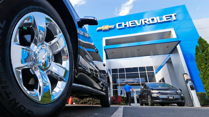 This Wednesday, April 26, 2017, photo shows the logo on the wheel of an SUV in front of a Chevrolet dealership in Richmond, Va. General Motors and Ford each posted strong U.S. sales in September 2017, confirming predictions that the industry could rebound for the month.