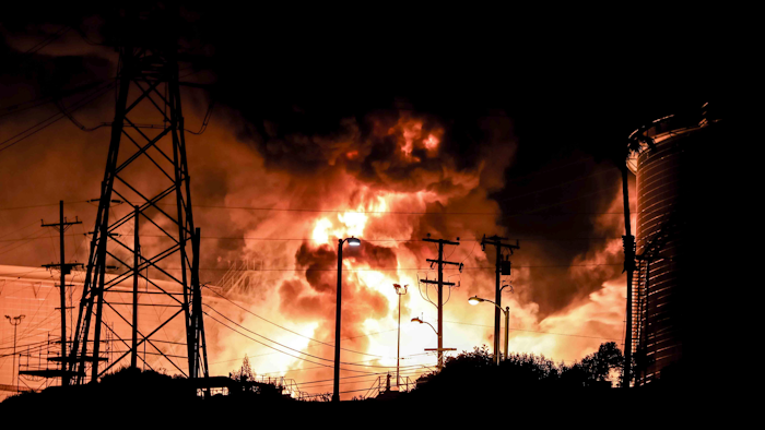 In this Tuesday, Oct. 17, 2017, photo provided by Jack Zellweger, a fire rages at the Chevron El Segundo Refinery in El Segundo, Calif. A fire that erupted at the West Coast's largest oil refinery threatened storage tanks and sent huge flames into the sky and black smoke across neighborhoods before crews quickly smothered it. Dozens of firefighters responded late Tuesday to the 1,000-acre refinery just south of Los Angeles, which processes nearly 275,000 gallons of crude per day.