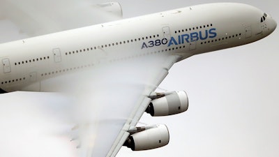 In this file photo, vapor forms across the wings of an Airbus A380 as it performs a demonstration flight at the Paris Air Show.