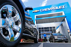 This Wednesday, April 26, 2017, photo shows the logo on the wheel of an SUV in front of a Chevrolet dealership in Richmond, Va. General Motors and Ford each posted strong U.S. sales in September 2017, confirming predictions that the industry could rebound for the month.