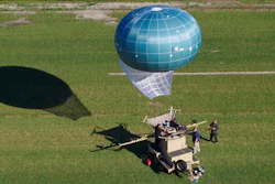 In this undated aerial photo provided by Drone Aviation Corp. shows a tethered balloon, called Winch Aerostat Small Platform, or WASP. The U.S. Border Patrol is considering another type of surveillance balloon to spot illegal activity. It’s part of an effort to see if more eyes in the sky translate to fewer illegal border crossings.