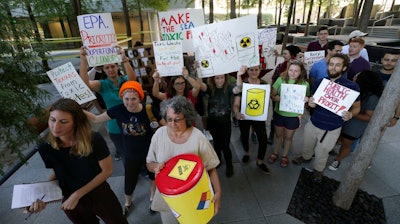 Member of the Texas Campaign for the Environment prepare to deliver over 2,300 letters from Texas families to the Environmental Protection Agency's Region VI office in Dallas, Thursday, Oct. 12, 2017. The letters are calling for saving federal cleanup programs under the Trump Administration. The EPA has approved a plan to remove sediments laced with highly toxic dioxin from a partially submerged Superfund site near Houston damaged during Hurricane Harvey.