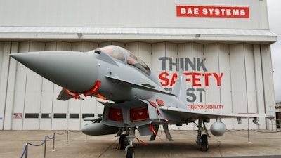 This is a Sept. 7, 2012 file photo of a Eurofighter Typhoon at BAE Systems, Warton Aerodrome, near Warton northwest England. British defense company BAE Systems is cutting almost 2,000 jobs in its military, maritime and intelligence services in an effort to boost competitiveness. CEO Charles Woodburn said in a statement Tuesday Oct. 10, 2017, that the actions are necessary to 'align our workforce capacity more closely with near-term demand and enhance our competitive position to secure new business.'