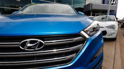 In this Friday, Oct. 6, 2017, photo, a 2017 Santa Fe sports utility vehicle sits outside a Hyundai dealership in the south Denver suburb of Littleton, Colo. Battered by dramatically falling sales for the past five years, Hyundai is training its dealers to make the car-buying experience easier for consumers.