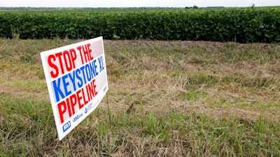 In this July 29, 2017 file photo, a sign reading: 'Stop the Keystone XL Pipeline' sits in the proposed path of the Keystone XL pipeline, in Silver Creek, Neb. The Trump administration says a federal judge has no authority to second-guess a presidential permit for the project.
