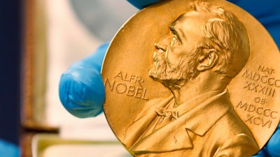 A national library employee shows the gold Nobel Prize medal awarded to the late novelist Gabriel Garcia Marquez.