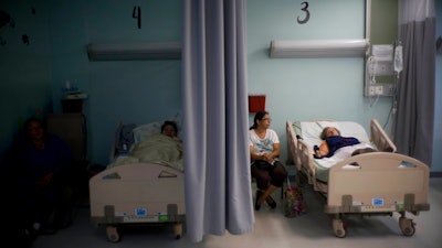 In this Thursday, Sept. 28, 2017, file photo, patients lie in their beds at a hospital in Catano, Puerto Rico. The U.S. Food and Drug Administration says drug shortages are possible because of expected long-term power outages in Puerto Rico. FDA Commissioner Dr. Scott Gottlieb said in a statement Friday, Oct. 6, 2017, that the agency is working to prevent shortages of about 40 medicines. He didn't name the medicines involved.