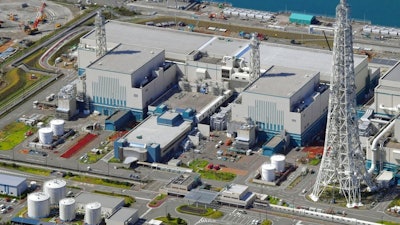 This Sept. 30, 2017 aerial photo shows the reactors of No. 6, right, and No. 7, left, at Kashiwazaki-Kariwa nuclear power plant, Niigata prefecture. Japanese nuclear regulators say two reactors run by the utility blamed in the Fukushima plant meltdowns have met their safety standards, saying the operator has since taken sufficient measures at another plant it owns. The Nuclear Regulation Authority unanimously approved Wednesday, Oct. 4, 2017, a draft certificate for No. 6 and No. 7 reactors at the plant in northern Japan operated by the Tokyo Electric Power Co. under stricter standards set after the 2011 Fukushima disaster.