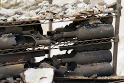 The remains of burned bottles of wine are seen at the Signorello Estate winery Tuesday, Oct. 10, 2017, in Napa, Calif. Worried California vintners surveyed the damage to their vineyards and wineries Tuesday after wildfires swept through several counties whose famous names have become synonymous with fine food and drink.