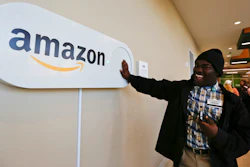In this Monday, Oct. 16, 2017, photo, Zavian Tate, a student at the University of Alabama at Birmingham, pushes a large Amazon Dash button, in Birmingham, Ala. The large Dash buttons are part of the city's campaign to lure Amazon's second headquarters to Birmingham.