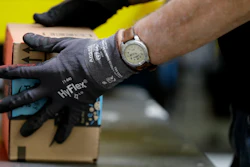 An employee packages a product at the Amazon Fulfillment center in Robbinsville Township, N.J. On Wednesday, Oct. 25, 2017, Amazon said that it will launch a new service in November that will let delivery people inside homes to drop off packages.