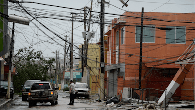 In this Wednesday, Sept. 20, 2017 file photo, power lines are down after the impact of Hurricane Maria, which hit the eastern region of the island in Humacao, Puerto Rico. In the wake of Hurricane Maria, Facebook pledged to send a 'connectivity team' to help restore communications in ravaged Puerto Rico. It's just one of several tech companies - among them Tesla, Google, Cisco, Microsoft and a range of startups - with their own disaster response proposals, most aimed at getting phone and internet service up and running.