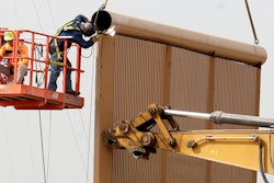 Crews work on a border wall prototype near the border with Tijuana, Mexico, Thursday, Oct. 19, 2017, in San Diego. Companies are nearing an Oct. 26 deadline to finish building eight prototypes of President Donald Trump's proposed border wall with Mexico.