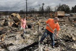 Sarah Boryszewski is helped by her father Gerald Peete as they dig for belongings in the remains of Boryszewski's home in Coffey Park, Friday Oct. 20, 2017 in Santa Rosa, Calif. Northern California residents who fled a wildfire in the dead of night with only minutes to spare returned to their neighborhoods Friday for the first time in nearly two weeks to see if anything was standing.