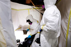 In this Oct. 18, 2017, photo, Asbestos Removal Technologies Inc., superintendent Ryan Laitila, right, sprays amended water, as job forman Megan Eberhart bags ceiling material during asbestos abatement in Howell, Mich. Spurred by the chemical industry, President Donald Trump’s administration is retreating from a congressionally mandated review of some of the most dangerous chemicals in public use. The review began under Trump’s predecessor to make sure proper safeguards are in place for asbestos and other toxins in homes, offices and industrial plants across the United States.