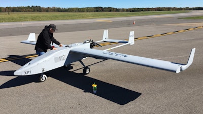 In this Oct. 17, 2017 photo, Mike Busutil of Navmar Applied Sciences Corporation prepares to do flight tests with a Tigershark drone at Griffiss International Airport in Rome, N.Y. New York state is investing $30 million to create a 50-mile drone-testing corridor between Rome and Syracuse.