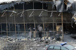 Police investigators inspect the site of an explosion and fire at a fireworks factory in Tangerang, on the outskirts of Jakarta, Indonesia, Friday, Oct. 27, 2017. Investigators Friday were trying to determine the cause of the fire that killed dozens of people, mostly young female workers unable to escape.