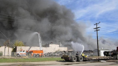 Smoke rises in the air as firefighters battle a fire at the Ames Plant #1 in Parkersburg, W.Va., Sunday, Oct. 22, 2017.