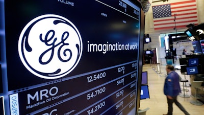 In this Monday, June 12, 2017, file photo, the General Electric logo appears above a trading post on the floor of the New York Stock Exchange. General Electric is naming Trian’s Ed Garden to its board, potentially signaling a shift toward becoming a leaner, industrial player that the investment fund has been pushing for years.