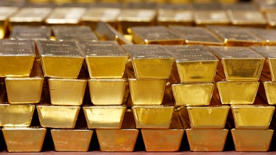 In this Tuesday, July 22, 2014, file photo, gold bars are stacked in a vault at the United States Mint, in West Point, N.Y. Over the last year the prices of metals have surged, and experts say they might stay high for a while. But getting in on those gains as an investor can be a challenge.