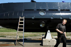 This April 30, 2008 file photo, shows a submarine and its owner Peter Madsen. Police in Denmark said Monday, Oct. 30, 2017, a Danish inventor has admitted dismembering a Swedish journalist who disappeared from his submarine, but says he did not kill her.