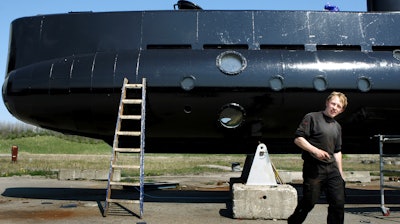 This April 30, 2008 file photo, shows a submarine and its owner Peter Madsen. Police in Denmark said Monday, Oct. 30, 2017, a Danish inventor has admitted dismembering a Swedish journalist who disappeared from his submarine, but says he did not kill her.