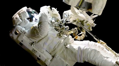 In this image from video made available by NASA, astronaut Joe Acaba performs a spacewalk outside the International Space Station on Friday, Oct. 20, 2017. Acaba was barely outside an hour when he had to replace one of his safety tethers. Spacewalking astronauts always have more than one of these crucial lifelines in case one breaks. They also wear a jetpack in case all tethers fail and they need to fly back to the space station.