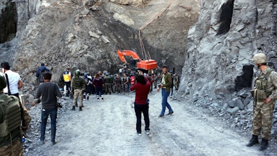 Turkish soldiers stand guard as rescue workers work after six miners were killed inside a collapsed coal mine in Sirnak in southeast Turkey, Tuesday, Oct. 17, 2017. The private Dogan news agency said the incident occurred Tuesday in the province of Sirnak, near Turkey's borders with Iraq and Syria. The cause of the accident was not immediately known.