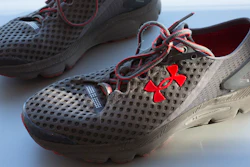 In this Monday, Jan. 4, 2016, file photo, a pair of Under Armour SpeedForm Gemini 2 Record Equipped running shoes, containing an embedded chip to track exercise, are displayed in New York. Under Armour Inc. reports earnings Tuesday, Oct. 31, 2017.